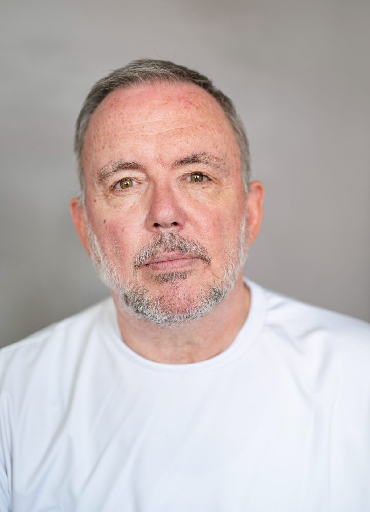 Charlie Lark in a white t-shirt on a light background
